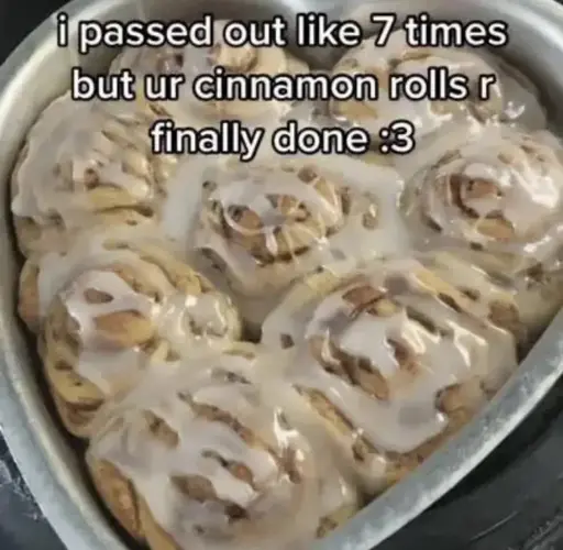 the caption "i passed out like 7 times but ur cinnamon rolls r finally done :3" on a picture of a heart shaped tray baking tray with cinnamon rolls with white icing